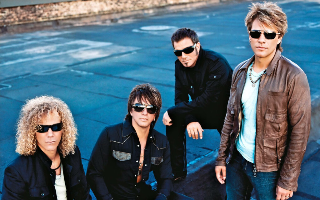 Bon Jovi 2010 The Circle Tour band posing on urban rooftop in stylish jackets and sunglasses Wallpaper