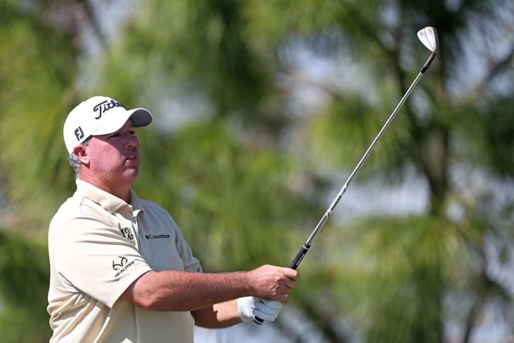 Boo Weekley swinging golf club intense focus vibrant green outdoor golf wallpaper background