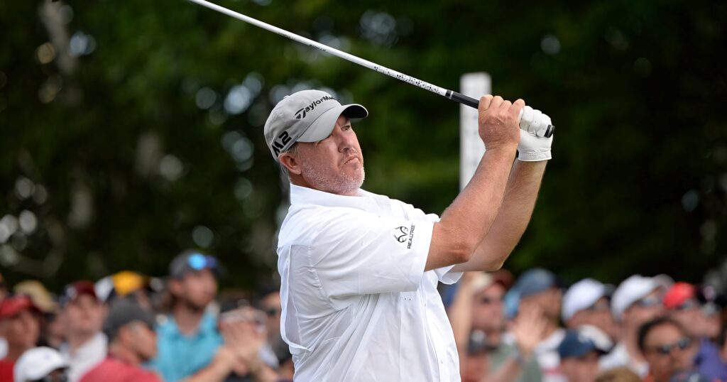 Boo Weekley mid swing in white polo on green golf course focused professional golfer wallpaper