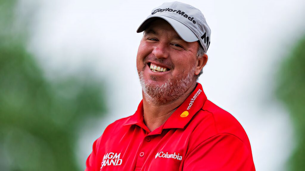 Boo Weekley smiling in red Columbia golf shirt and gray TaylorMade cap outdoors wallpaper