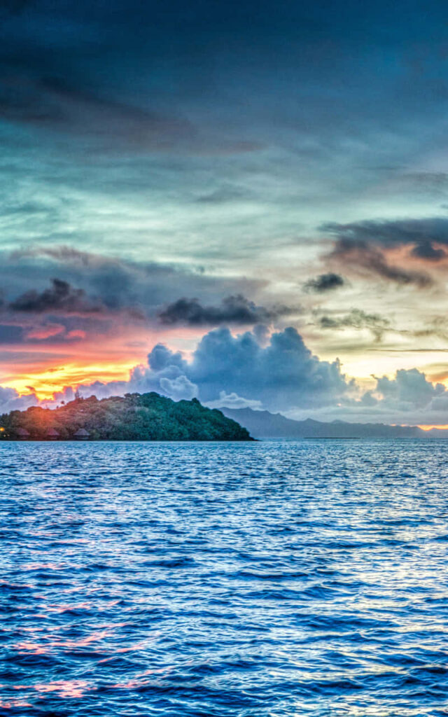 Bora Bora sunset wallpaper with vibrant sky crystal clear blue waters and lush tropical island