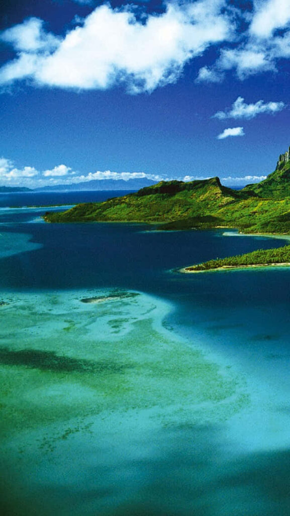 Bora Bora tropical island with turquoise waters lush green hills and vibrant blue sky wallpaper