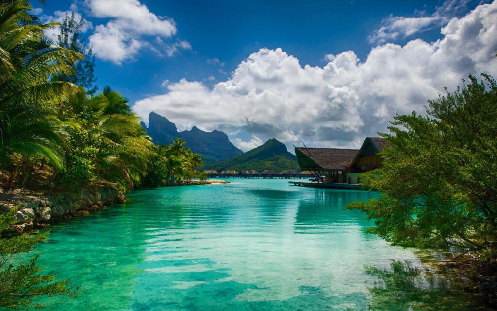 Bora Bora wallpaper with turquoise water lush palms overwater bungalows and dramatic mountains