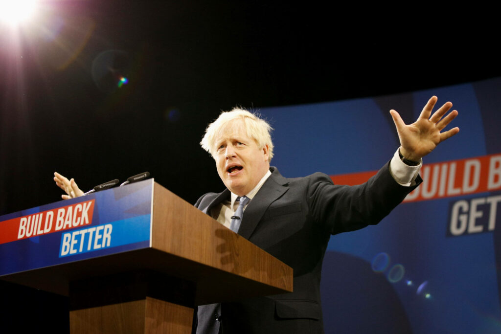 Boris Johnson speaking Build Back Better wallpaper blue backdrop dynamic political leadership energy