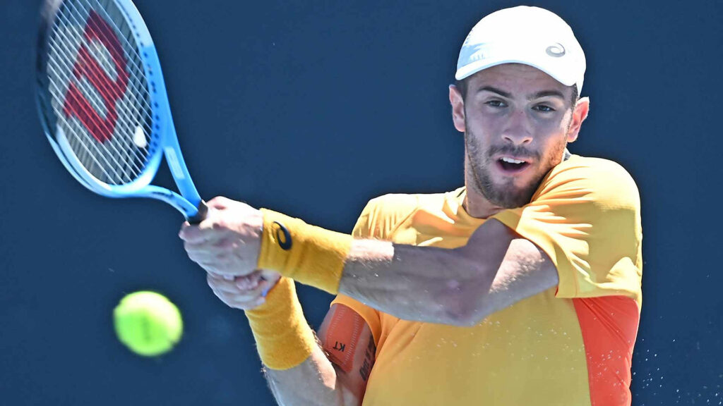 Borna Coric focused on tennis ball mid-shot vibrant action dynamic movement colorful wallpaper