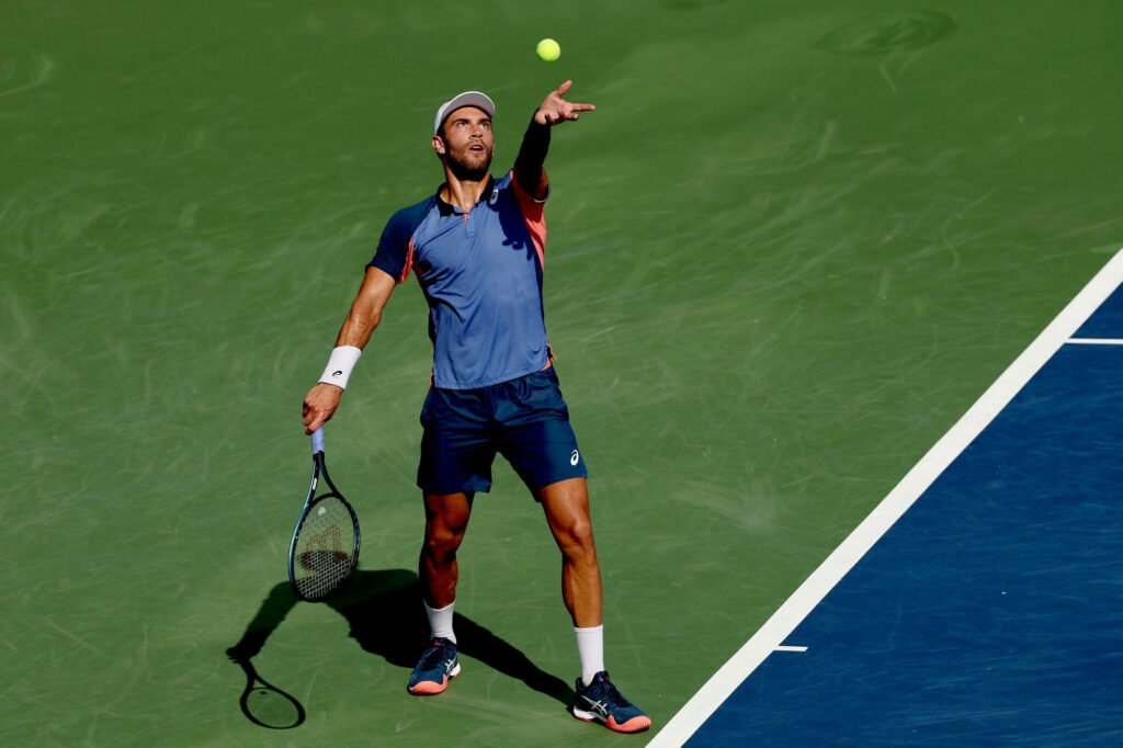 Borna Coric mid-serve intense focus green hard court tennis wallpaper background dynamic stance