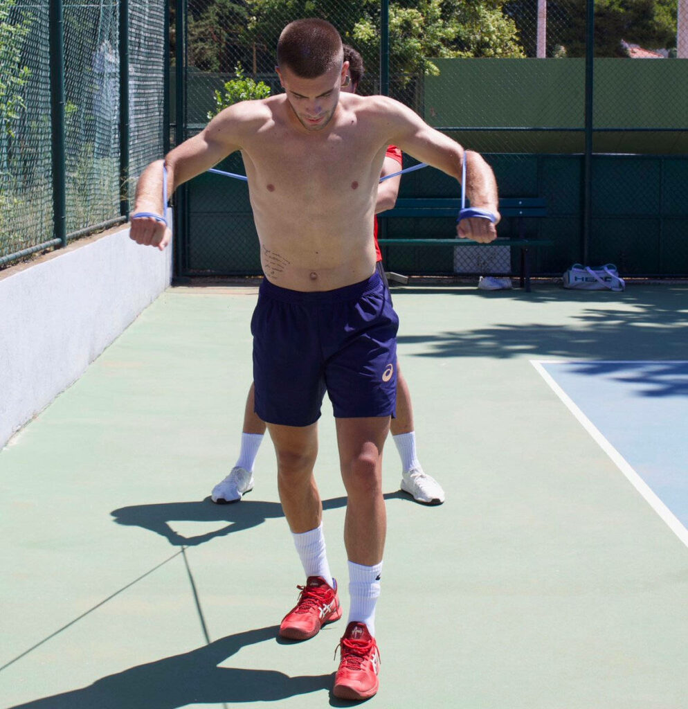 Borna Coric tennis training outdoors in athletic shorts red shoes dynamic workout on sunny court Wallpaper