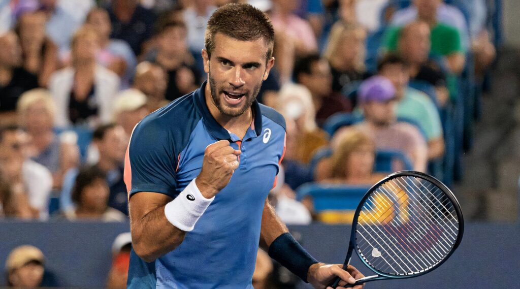 Borna Coric tennis victory fist pump intense expression blue court vibrant stadium wallpaper