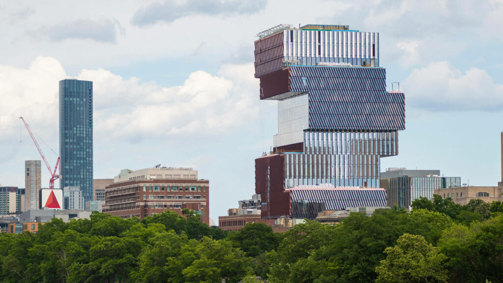 Boston University Data Sciences building geometric architecture with cityscape and greenery background Wallpaper