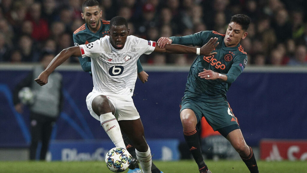 Boubakary Soumaré skillfully controls ball in intense football match with vibrant stadium lights Wallpaper