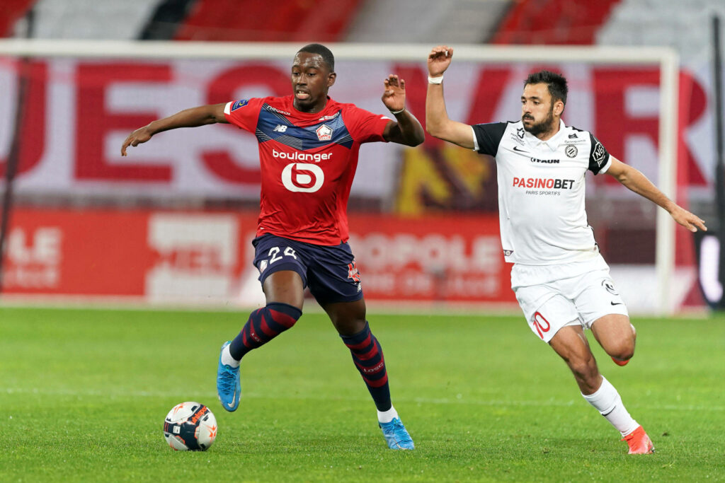 Boubakary Soumaré challenges Gaëtan Laborde Montpellier football match vibrant stadium action Wallpaper