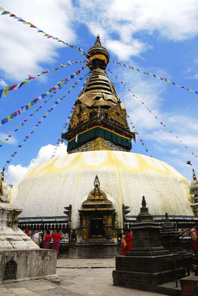 Boudhanath Stupa white dome gilded spire colorful prayer flags Nepal Buddhist monument wallpaper