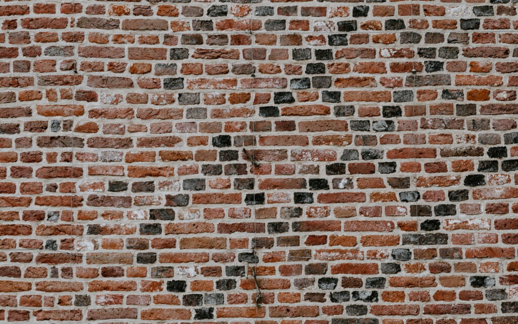 Earthy Elegance: Captivating Brown Brick Wall Texture for QHD Wallpaper