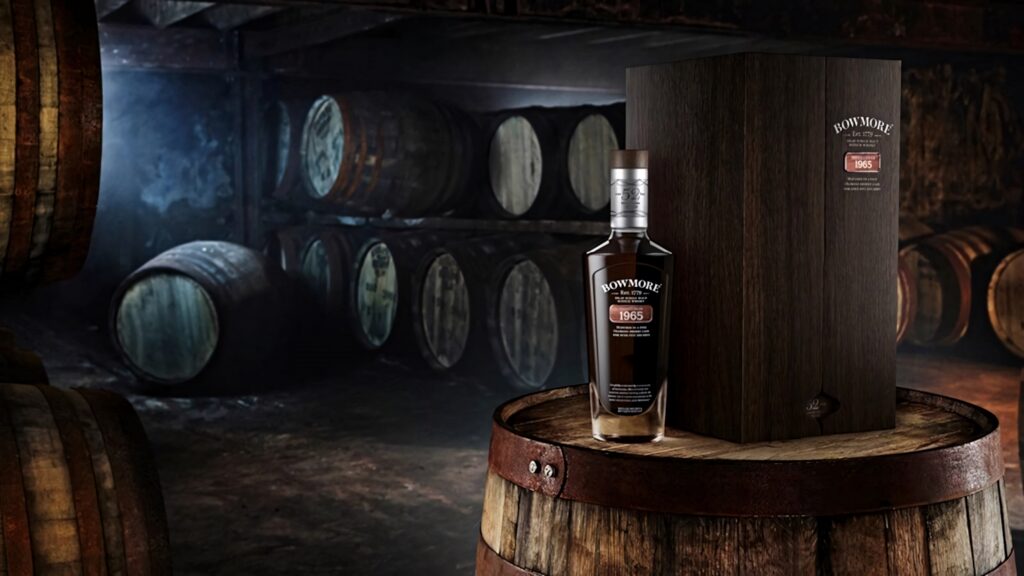 Bowmore 1965 Whisky bottle with wooden case on barrel in rustic aging cellar rich amber tones Wallpaper