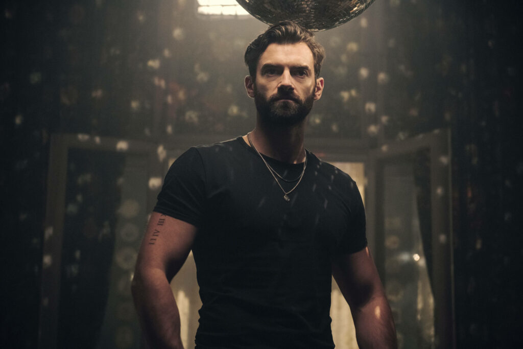 Brad Cage from Army of Thieves wallpaper with intense focused expression under dramatic light