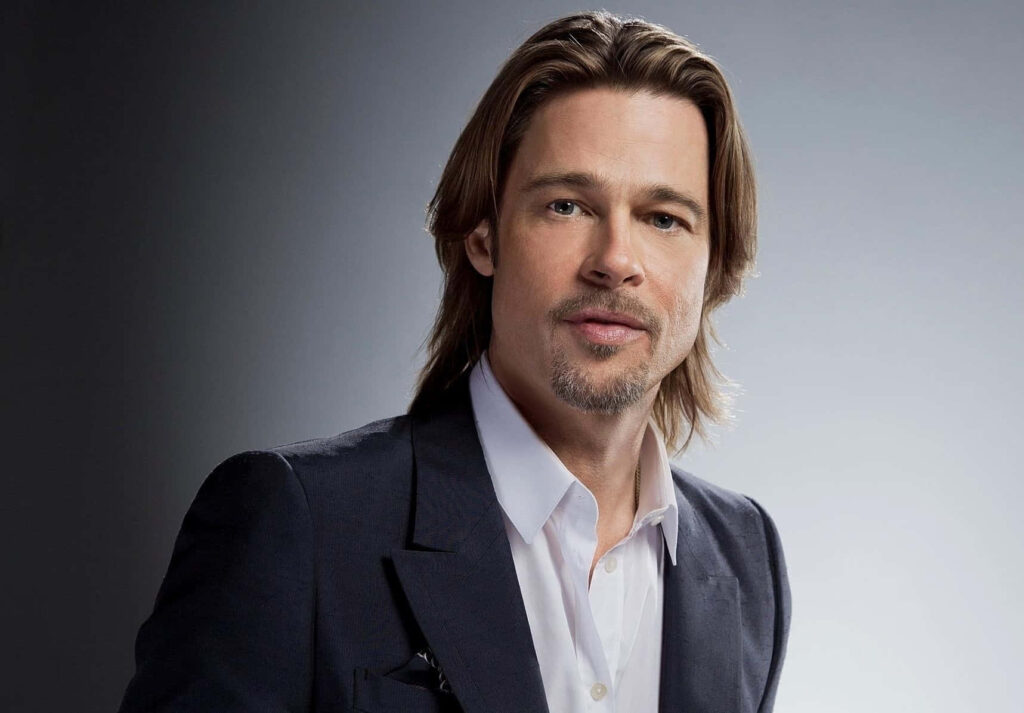 Brad Pitt in classic suit confident charm studio background celebrity wallpaper image