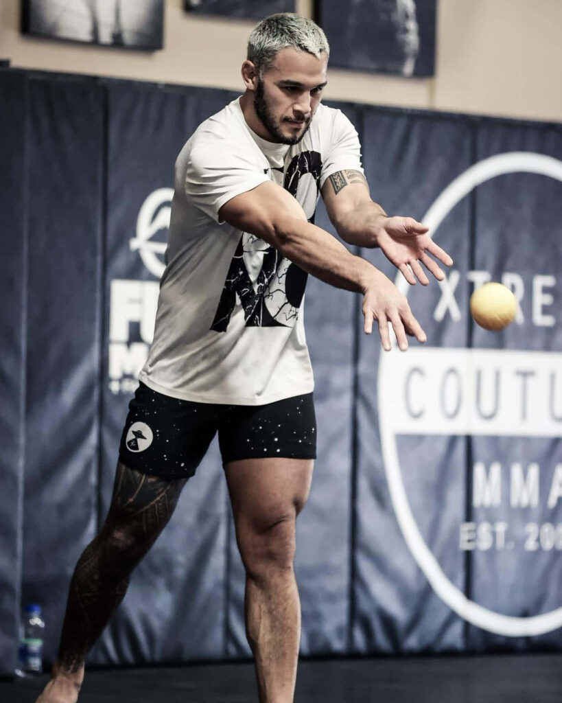 Brad Tavares MMA fighter throwing ball in gym intense focus athletic training high resolution wallpaper