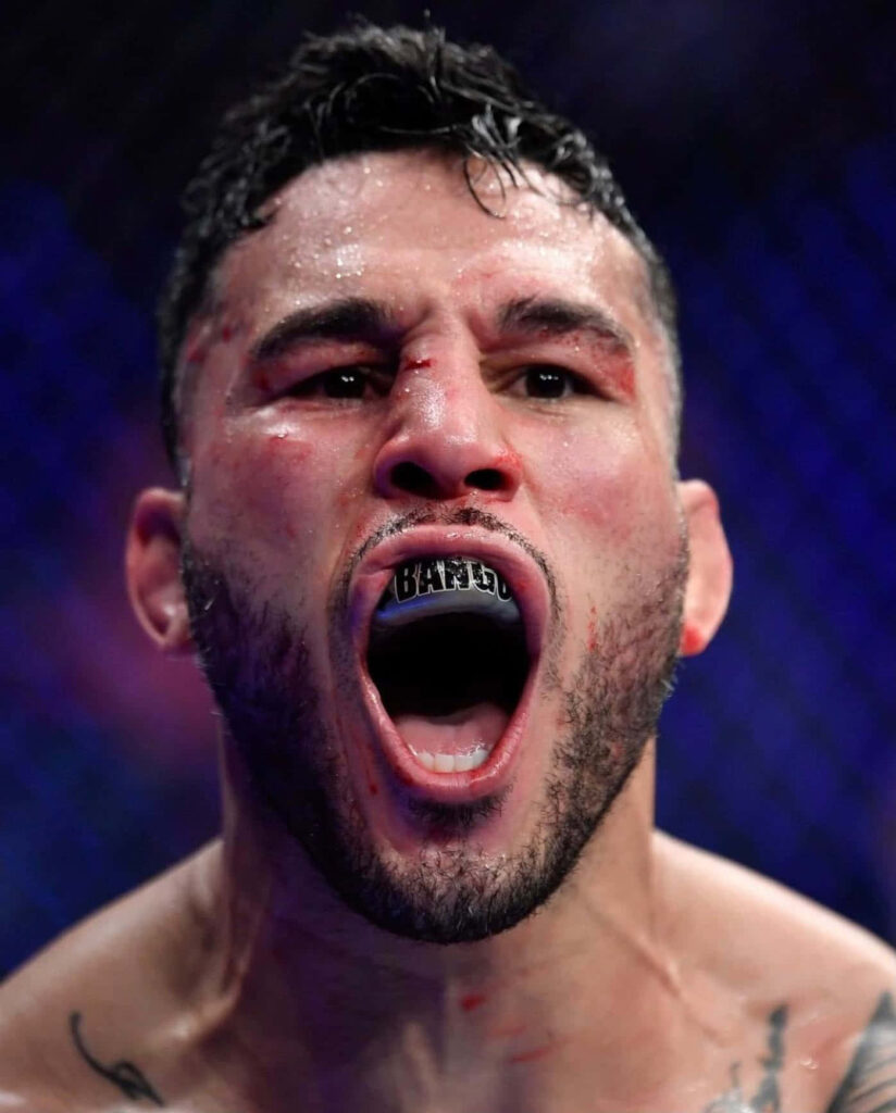 High-resolution UFC fighter Brad Tavares intense expression with mouth guard inside octagon wallpaper