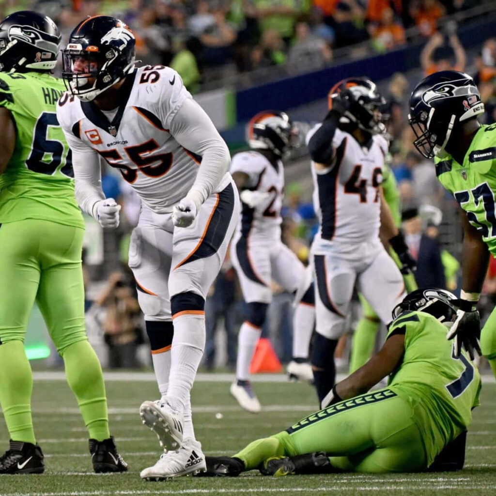 Bradley Chubb Denver Broncos celebrating intense NFL game action vibrant white orange uniform Wallpaper