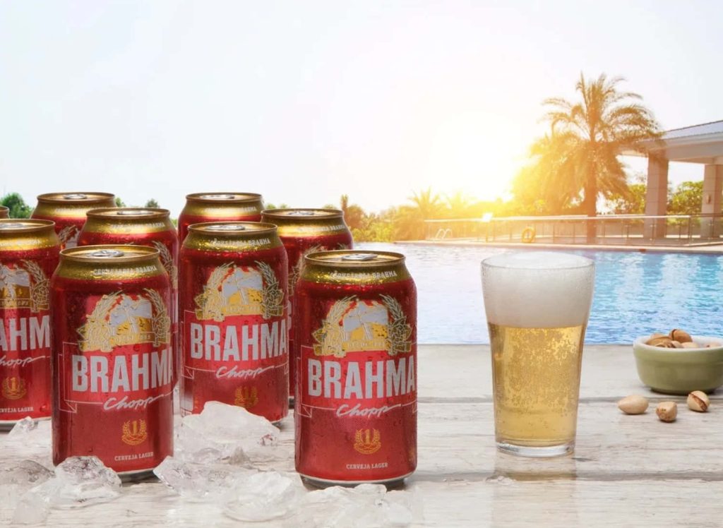 Brahma Chopp beer cans and foamy glass on ice by sunny poolside with tropical summer vibe Wallpaper