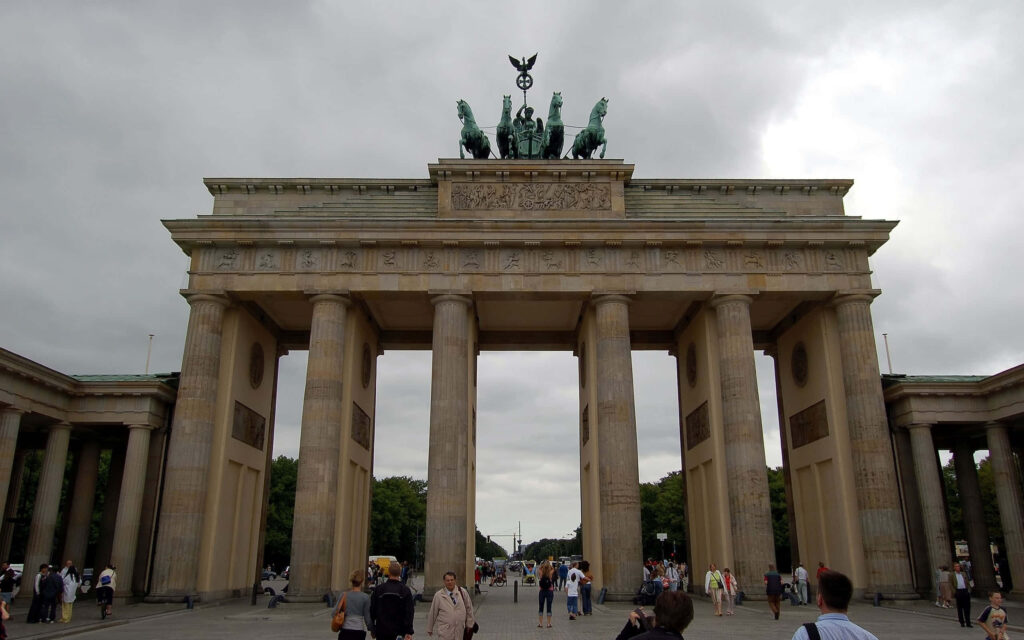 Brandenburg Gate Berlin neoclassical architecture under dramatic cloudy sky urban atmosphere wallpaper