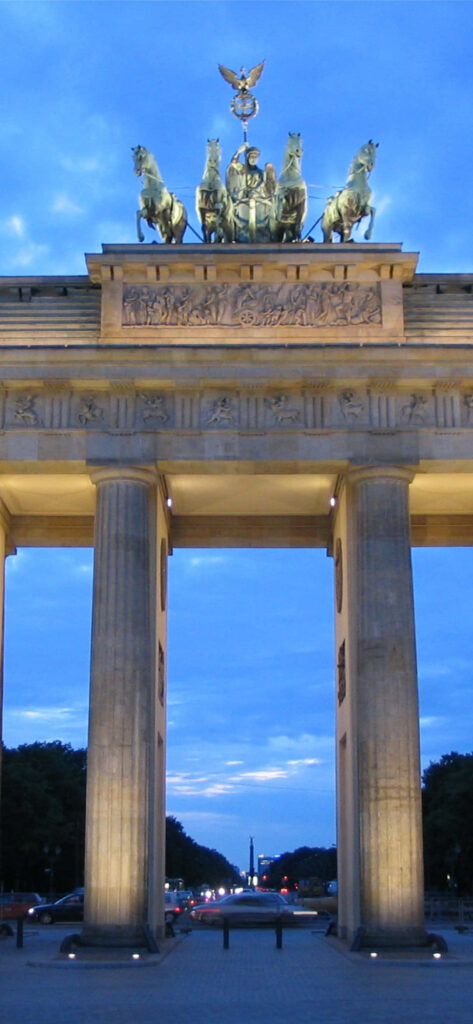 Brandenburg Gate Quadriga illuminated at night with detailed columns vibrant Berlin cityscape wallpaper