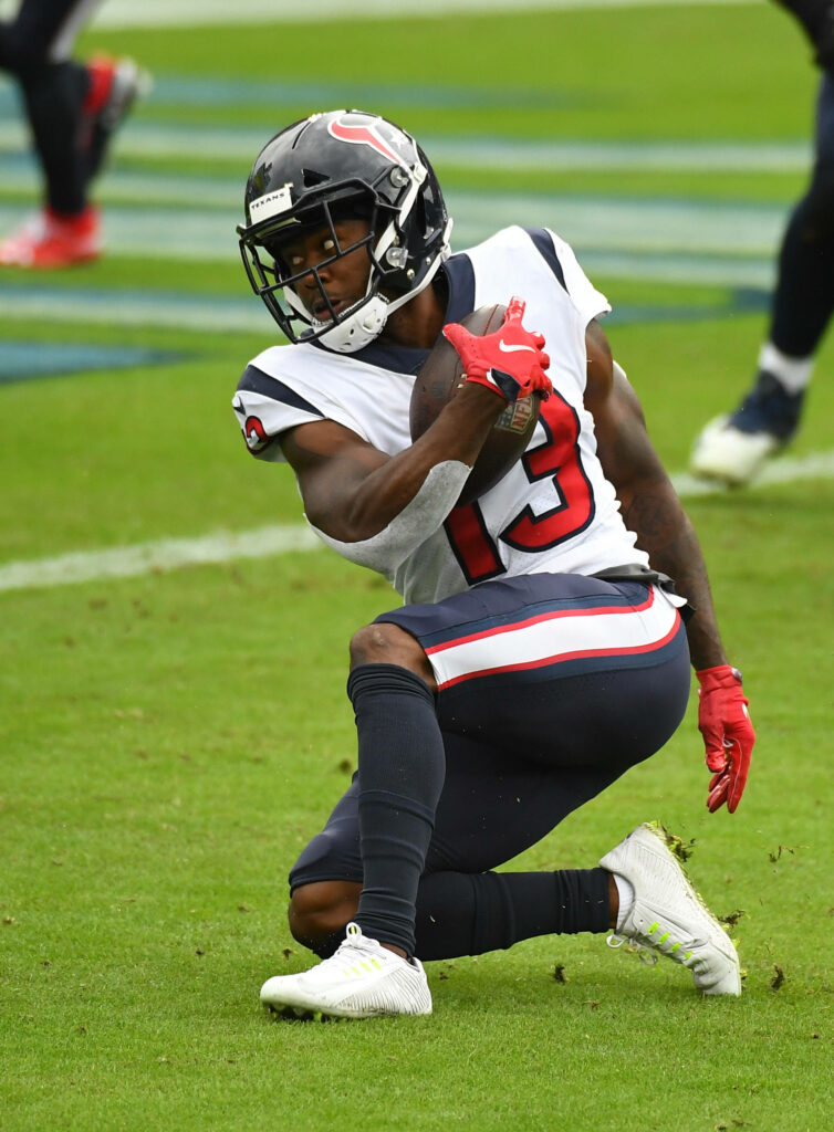 Brandin Cooks Houston Texans wide receiver kneeling with football on green field NFL game wallpaper
