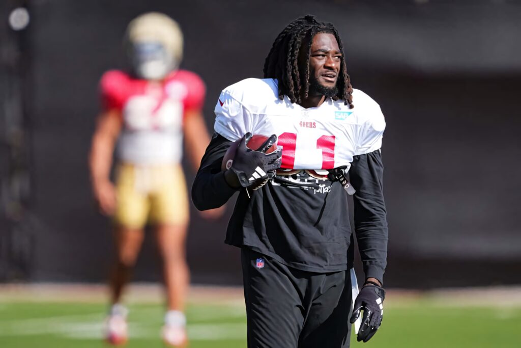 Brandon Aiyuk 49ers practice action with vibrant lighting and official team gear NFL wallpaper