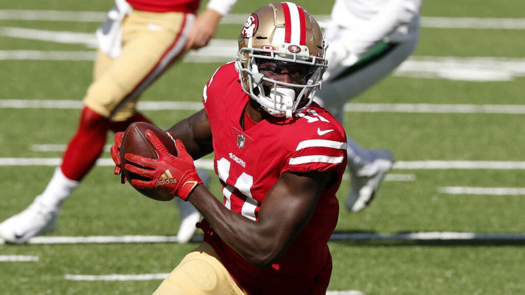 Brandon Aiyuk San Francisco 49ers catching football action in red gold uniform high resolution Wallpaper