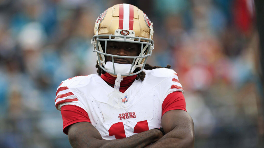 Brandon Aiyuk San Francisco 49ers intense game action wallpaper red and gold NFL background