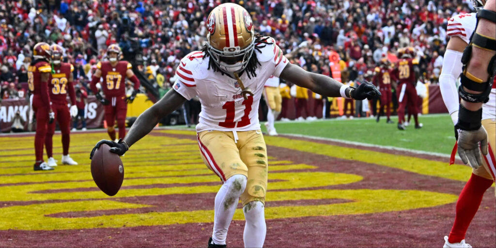 Brandon Aiyuk San Francisco 49ers touchdown celebration with vibrant stadium and fans background Wallpaper
