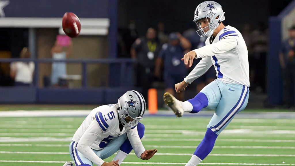 Brandon Aubrey Dallas Cowboys kicker mid field goal attempt on vibrant green turf high resolution Wallpaper