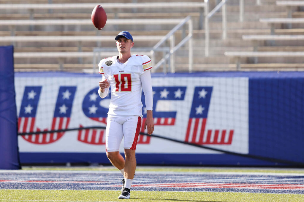 Brandon Aubrey in full USFL uniform on vibrant football field with stadium background wallpaper