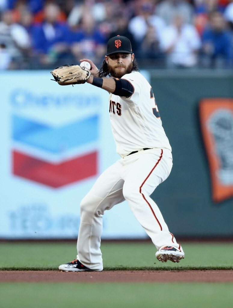 Brandon Crawford San Francisco Giants throwing baseball in white uniform vibrant stadium background Wallpaper