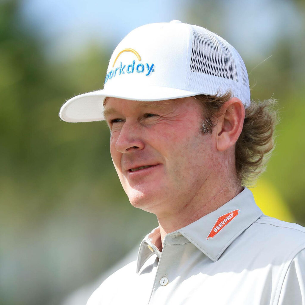 Brandt Snedeker close-up wearing white mesh-back Workday cap and gray golf shirt outdoors Wallpaper