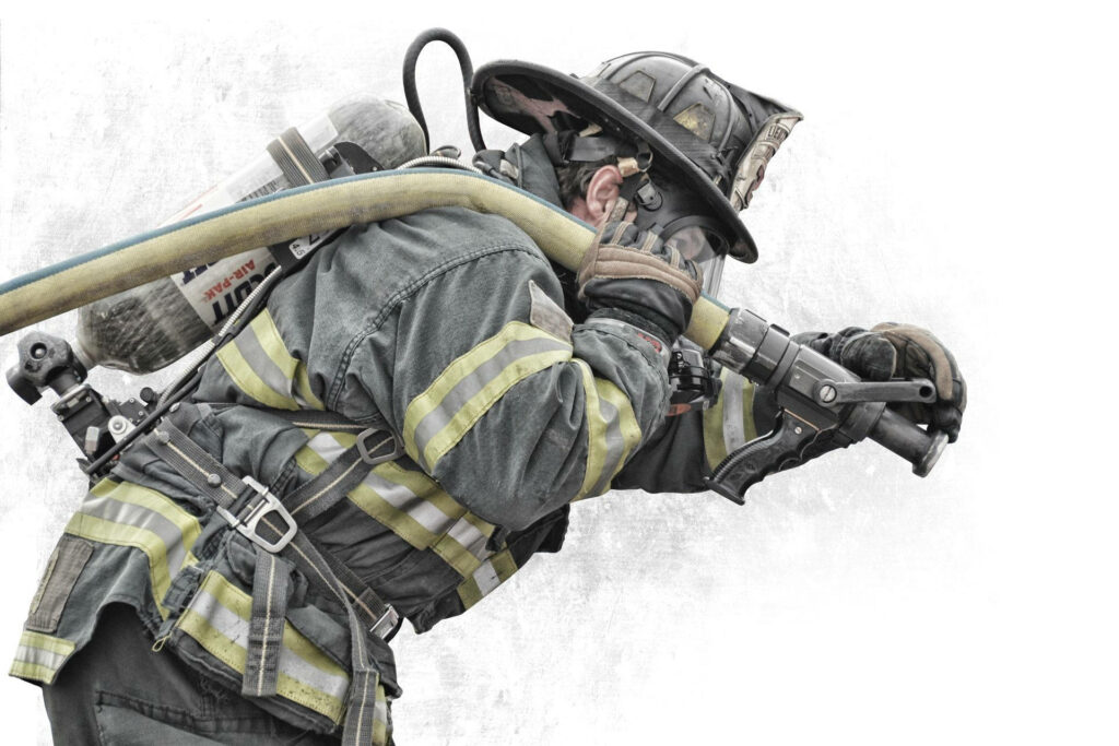 Fireman in full gear skillfully operating water hose artwork showcasing bravery and commitment Wallpaper