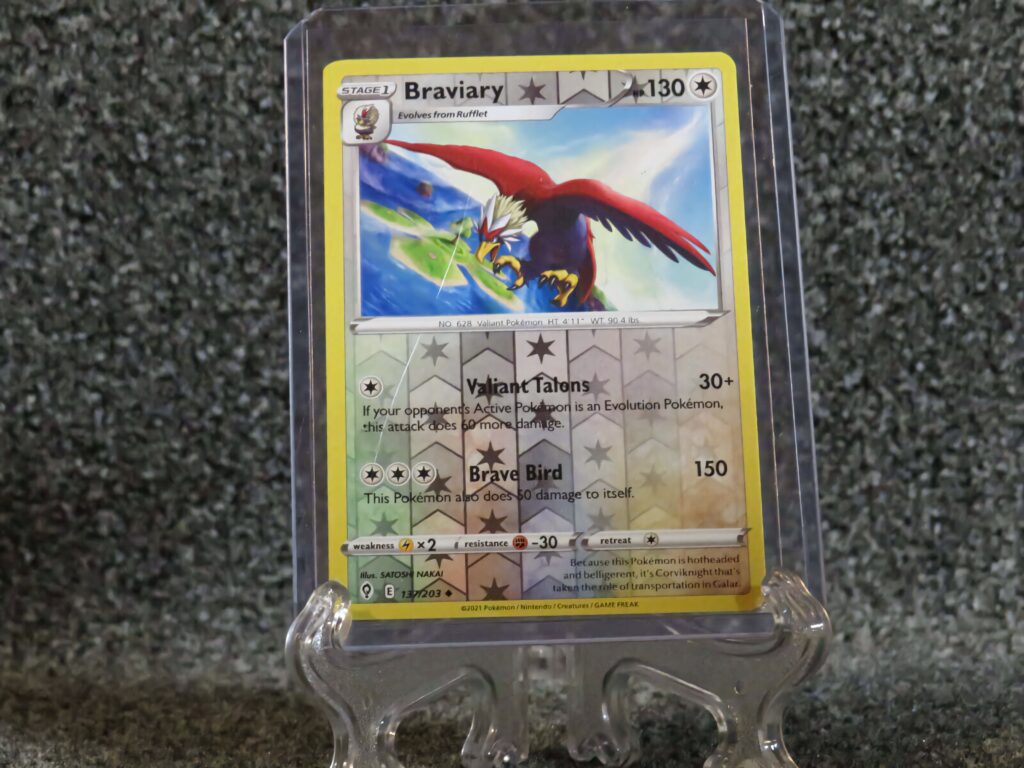Braviary Pokémon card in clear case soaring over rock background vibrant red blue white artwork Wallpaper