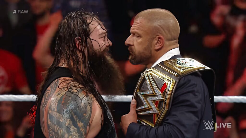 Bray Wyatt and Triple H intense WWE face-off in ring with championship belt dynamic wallpaper
