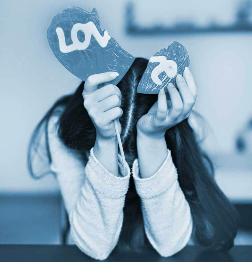 Sad girl holding broken heart with love text blue filter emotional heartbreak wallpaper background