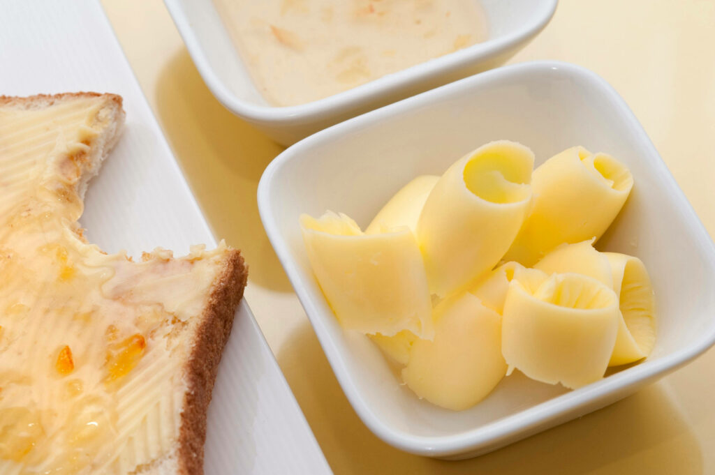 Breakfast Delight: Creamy Butter Curls & Toast with Jam - Wallpaper