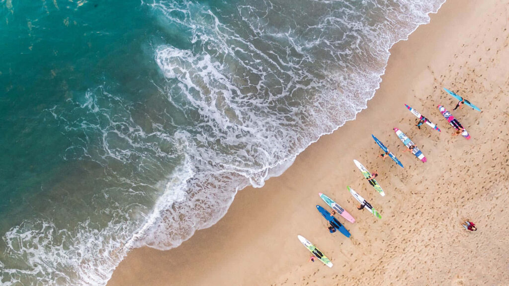 Breathtaking Aerial Beach View: Crystal Clear Waters & Golden Sand Wallpaper