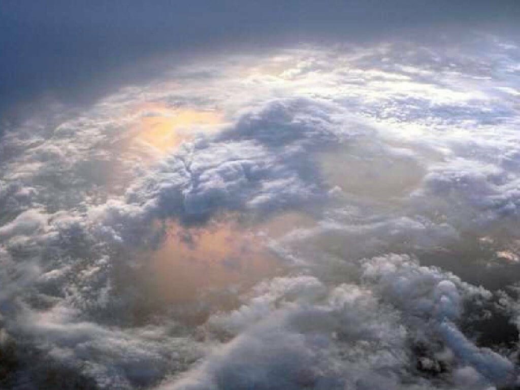 Ethereal Aerial View of Golden Cloud Formations - HD Wallpaper