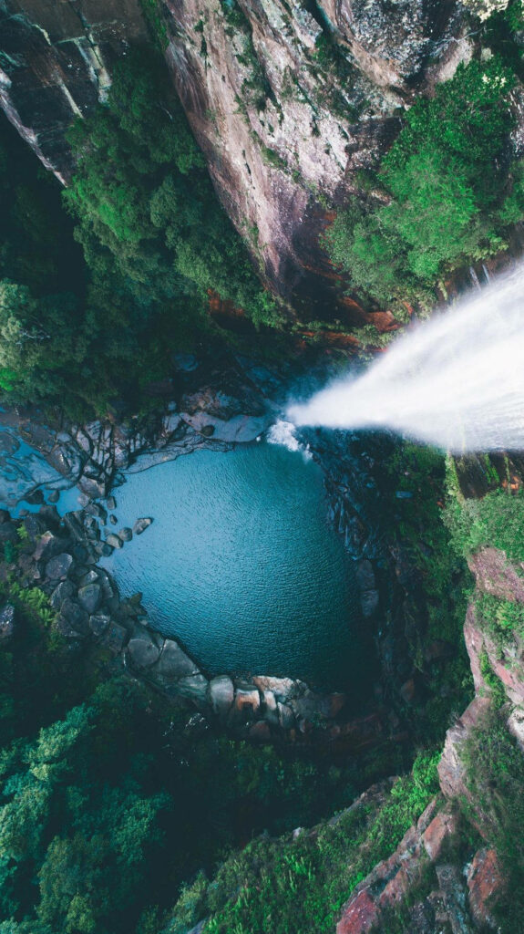 Breathtaking Waterfall Wallpaper: Aerial View of Teal Pool & Lush Greens