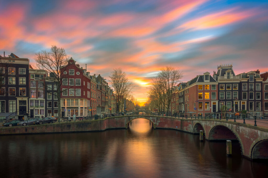 Serene Amsterdam Canal Wallpaper: Sunset, Architecture & Reflection