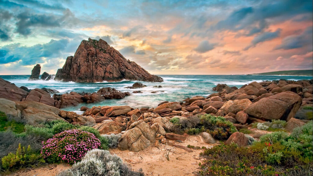 Serene Australian Beach Sunset: Rugged Rocks & Turquoise Waves Wallpaper