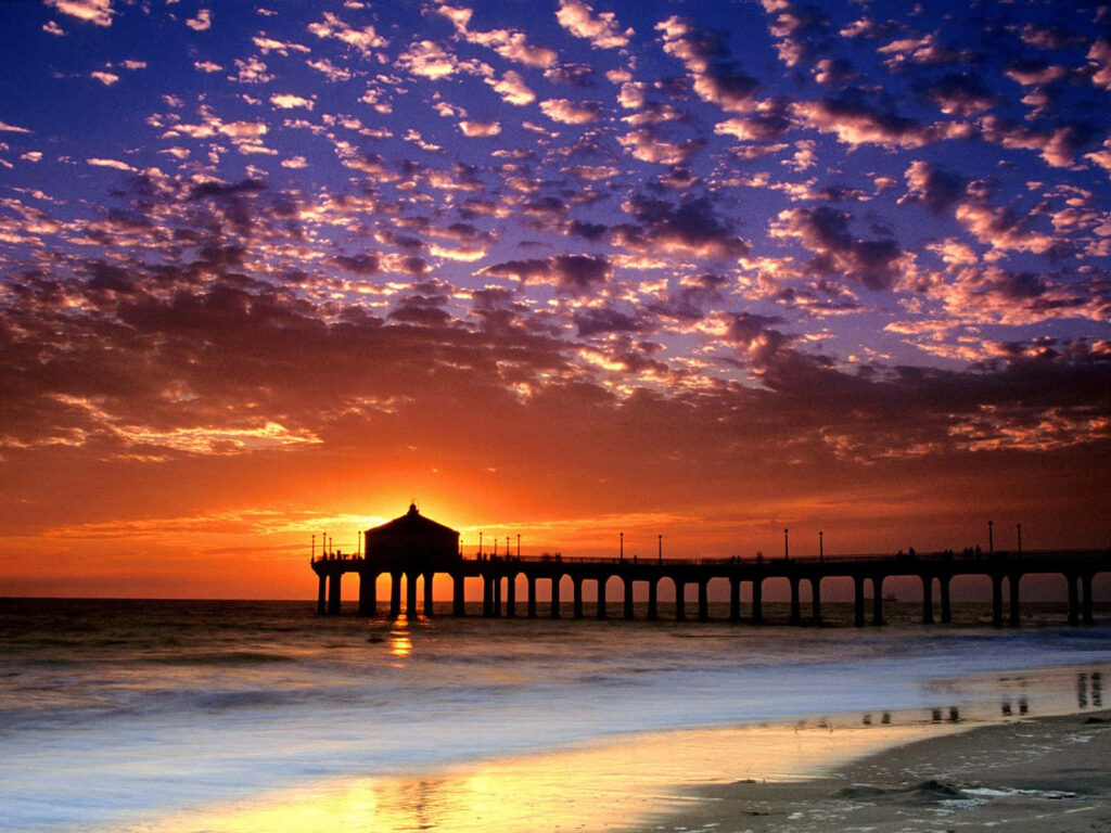 Breathtaking Sunset Over Serene Beach with Pier - Coastal Tranquility Wallpaper