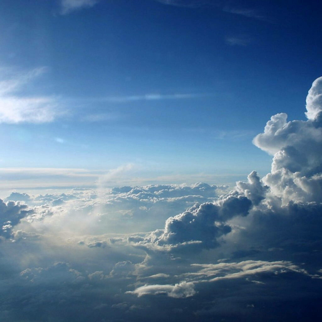 Captivating Canvas: Embracing Nature's Beauty through Billowing White Clouds on a Stunning Azure Sky Wallpaper
