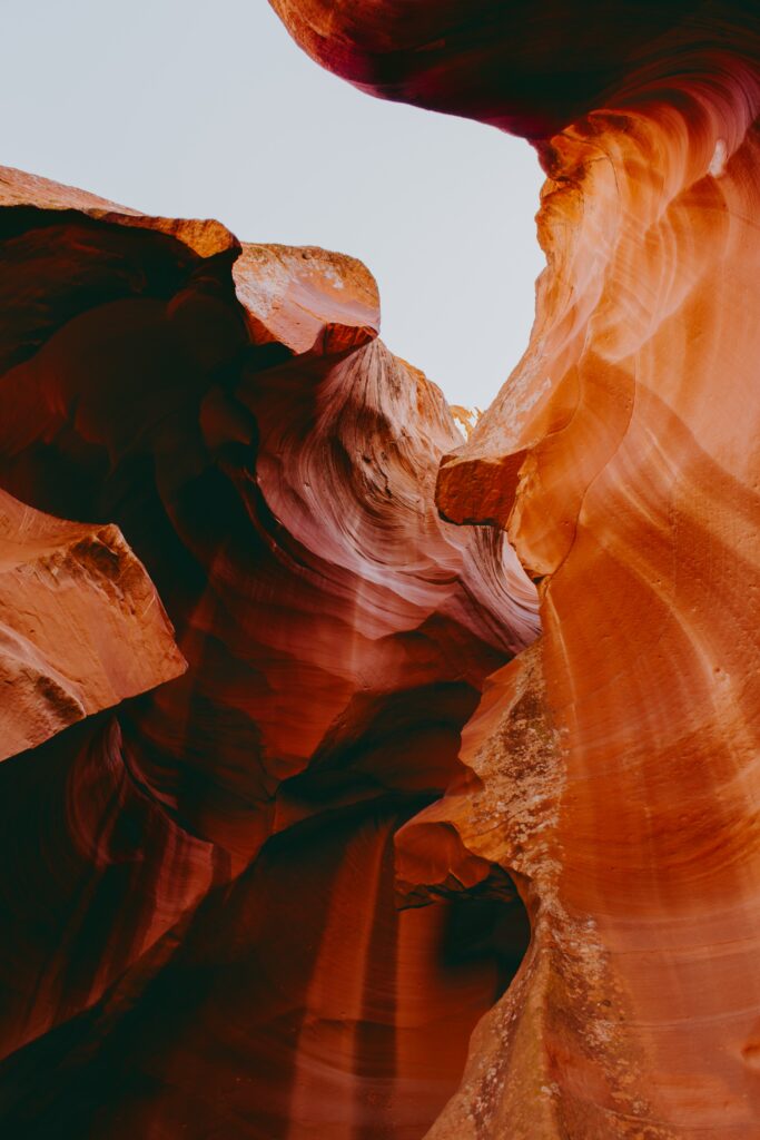 Breathtaking canyon wallpaper with towering brown cliffs and sculpted rock formations in warm tones