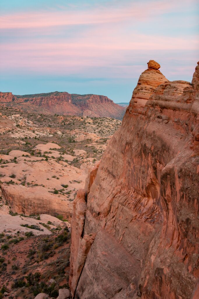 Breathtaking canyon landscape with towering cliffs and pastel pink blue evening sky wallpaper