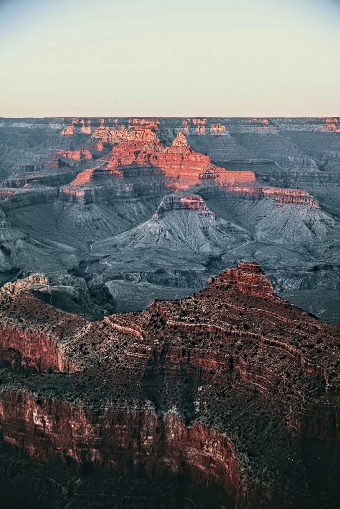 Breathtaking canyon landscape with towering rocky cliffs illuminated by warm sunlight wallpaper
